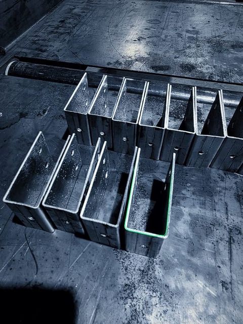A stack of formed steel brackets